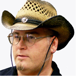 Western cowboy hat with curved brim, decorative cord, and center medallion for cowboy and rodeo costumes.