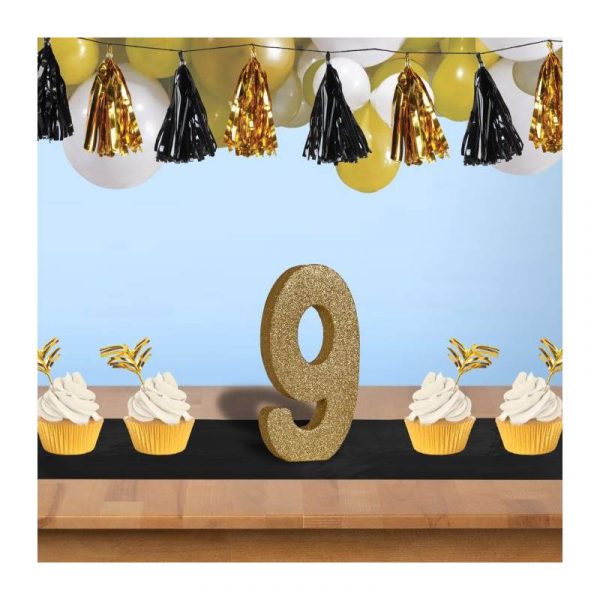 3D gold glittered numeral centerpiece staged