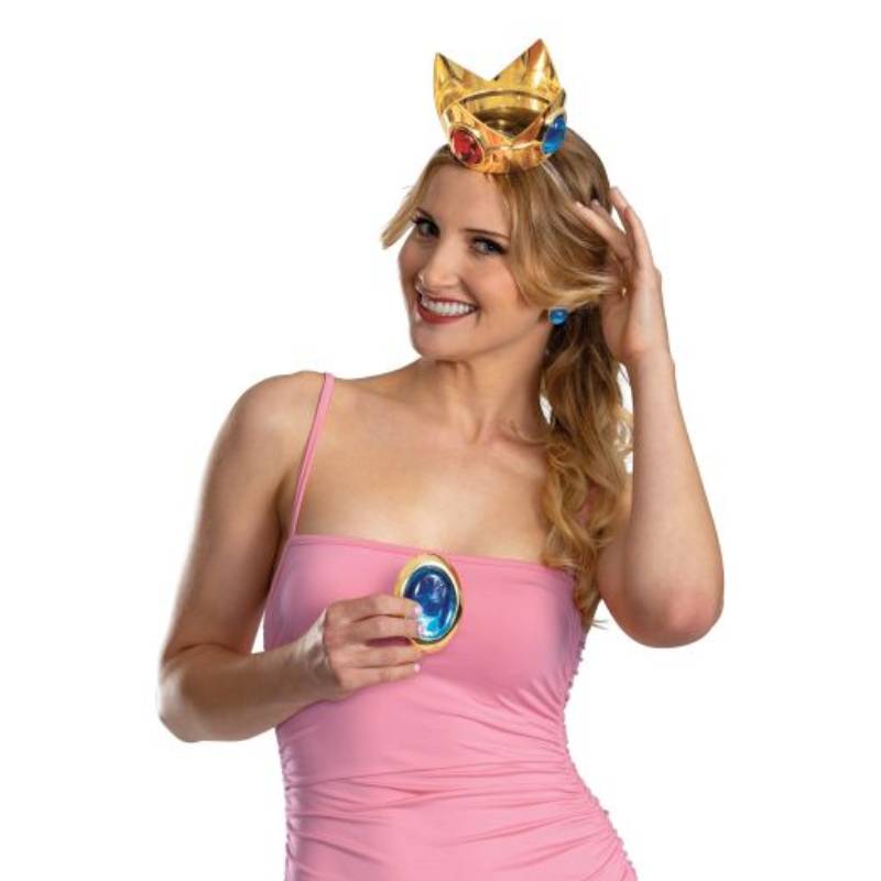 Adult wearing the Super Mario Princess Peach Accessory Kit with a gold-tone jeweled crown and blue oval costume accessory over a pink dress.