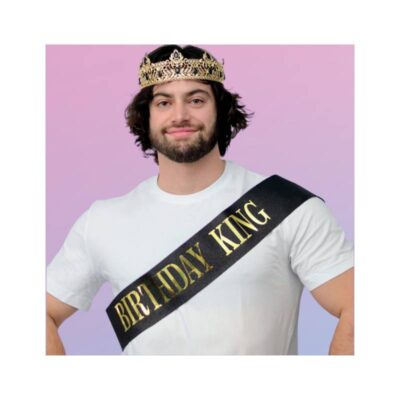 Adult wearing the Birthday King Deluxe Crown & Sash Set with an ornate gold-tone crown and black sash featuring metallic gold lettering.